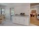 View of the dining area with a built-in cabinet that leads into the adjacent living area at 934 Lucas Ln, Oldsmar, FL 34677