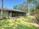 Exterior view of screened porch and lush, green lawn at 934 Lucas Ln, Oldsmar, FL 34677