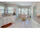 Eat-in kitchen featuring white cabinets, light countertops, and bright, windowed breakfast nook at 934 Lucas Ln, Oldsmar, FL 34677