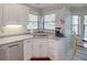 Kitchen area showcasing stainless steel appliances, a corner sink, and bright natural light at 934 Lucas Ln, Oldsmar, FL 34677