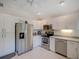 Bright kitchen featuring stainless steel appliances, white cabinets, and neutral countertops at 934 Lucas Ln, Oldsmar, FL 34677