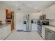 Bright kitchen with stainless steel appliances, white cabinets, and tiled flooring at 934 Lucas Ln, Oldsmar, FL 34677