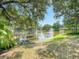 Scenic lake view with a gazebo, fountain and mature trees at 934 Lucas Ln, Oldsmar, FL 34677