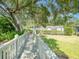 Elevated wooden walkway amidst lush greenery offers a peaceful escape with views of the well-maintained community at 934 Lucas Ln, Oldsmar, FL 34677