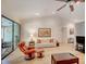Comfortable living room featuring hardwood floors, a ceiling fan, and access to a screened-in lanai at 934 Lucas Ln, Oldsmar, FL 34677