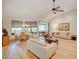 Open concept living space with hardwood floors, natural light, and access to an outdoor patio at 934 Lucas Ln, Oldsmar, FL 34677