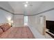 Bedroom showing carpet, a fan, and doorway to the main bathroom and closet at 934 Lucas Ln, Oldsmar, FL 34677