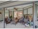 Covered patio with seating area and view into the living room at 934 Lucas Ln, Oldsmar, FL 34677
