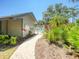Pathway to community pool, with colorful landscaping and greenery, creating a relaxing tropical retreat at 934 Lucas Ln, Oldsmar, FL 34677