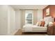 Comfortable bedroom with a plush bed, bedside table, artwork and a door, creating a calming retreat at 10270 Purple Leaf Ct, Riverview, FL 33578