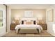 Stylish bedroom featuring a large bed, neutral tones, decorative pillows, and eye-catching art at 10270 Purple Leaf Ct, Riverview, FL 33578