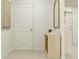 Hallway with a decorative table, mirror, and neutral color scheme on carpet flooring and modern art at 10270 Purple Leaf Ct, Riverview, FL 33578