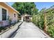 Long driveway leads to backyard oasis with outdoor dining, stock tank pool, and landscaped greenery at 1174 8Th N St, St Petersburg, FL 33701