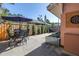 Back patio featuring an outdoor dining set, grilling area, and manicured privacy landscaping at 1174 8Th N St, St Petersburg, FL 33701