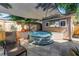 Relaxing backyard with galvanized stock tank pool under shade sail, surrounded by greenery and comfortable seating at 1174 8Th N St, St Petersburg, FL 33701