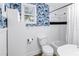 Bathroom featuring quirky wallpaper, modern fixtures, toilet, tub with shower, and natural lighting at 1174 8Th N St, St Petersburg, FL 33701