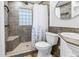 Tiled bathroom featuring glass block window and shower with seat, as well as modern fixtures at 1174 8Th N St, St Petersburg, FL 33701