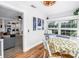 Bright dining area with built-in bench seating, adjacent to an open-concept kitchen and living space at 1174 8Th N St, St Petersburg, FL 33701