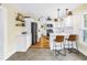 Modern kitchen with white cabinetry, stainless steel appliances, and stylish barstool seating at 1174 8Th N St, St Petersburg, FL 33701