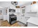 Modern kitchen featuring white cabinets, stainless steel appliances, and stylish backsplash at 1174 8Th N St, St Petersburg, FL 33701