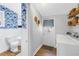 Convenient laundry room and half bath with tropical wallpaper at 1174 8Th N St, St Petersburg, FL 33701