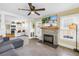 Spacious living room features a brick fireplace and an open layout into the modern kitchen at 1174 8Th N St, St Petersburg, FL 33701