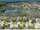 Expansive aerial view showcasing a neighborhood surrounding a picturesque lake with lush green spaces at 12352 Crestridge Loop, New Port Richey, FL 34655