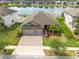 Aerial view of a beautiful home with lush landscaping and a peaceful lake in the neighborhood at 12352 Crestridge Loop, New Port Richey, FL 34655