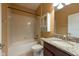 Bright bathroom with granite countertops, wooden cabinets, shower and bath combination, and recessed lighting at 12352 Crestridge Loop, New Port Richey, FL 34655