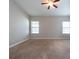 Spacious bedroom with carpet, ceiling fan, and two windows at 12352 Crestridge Loop, New Port Richey, FL 34655