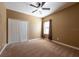 Bedroom with carpeted floors, closet with white doors, and natural light from a window at 12352 Crestridge Loop, New Port Richey, FL 34655