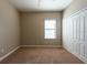 Bedroom with carpet flooring, closet with double doors and single window with blinds at 12352 Crestridge Loop, New Port Richey, FL 34655