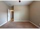 Bedroom features carpet flooring, open doorway and neutral paint throughout the room at 12352 Crestridge Loop, New Port Richey, FL 34655