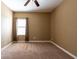Empty room features carpet floors, one window with blinds, and neutral wall paint at 12352 Crestridge Loop, New Port Richey, FL 34655