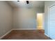 Bedroom features neutral paint color, carpet flooring and open doorway to another room at 12352 Crestridge Loop, New Port Richey, FL 34655