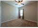 Bedroom features carpet flooring, single window with brown curtains and ceiling fan at 12352 Crestridge Loop, New Port Richey, FL 34655
