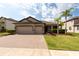 Charming home featuring a brick driveway, a two-car garage, and well-manicured landscaping at 12352 Crestridge Loop, New Port Richey, FL 34655