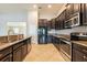 Kitchen featuring stainless steel appliances, granite countertop, and tile flooring at 12352 Crestridge Loop, New Port Richey, FL 34655