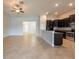 Bright, open-concept living space with tile flooring and kitchen access at 12352 Crestridge Loop, New Port Richey, FL 34655