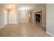 Bright living room featuring tile floors, neutral paint, and an open layout into the kitchen at 12352 Crestridge Loop, New Port Richey, FL 34655