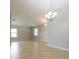 Large living room with tile flooring, neutral walls, and modern light fixtures at 12352 Crestridge Loop, New Port Richey, FL 34655