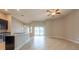 Spacious living room open to the kitchen, featuring tile floors and sliding doors to the lanai at 12352 Crestridge Loop, New Port Richey, FL 34655