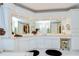 Bright bathroom features double sinks, white cabinetry, vanity with stool, and large mirror at 124 Barrington Dr, Brandon, FL 33511