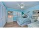 Bright bedroom with coastal mural, ceiling fan, white furniture, and wood floors at 124 Barrington Dr, Brandon, FL 33511
