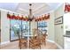 Elegant dining area with a glass-top table, chandelier, and views of the outdoor patio at 124 Barrington Dr, Brandon, FL 33511