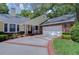 Inviting home showcasing a well-maintained front yard, brick accents, and a covered entryway with a swing at 124 Barrington Dr, Brandon, FL 33511