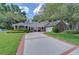Charming home with brick-lined driveway, manicured landscaping, attached garage, and welcoming front porch at 124 Barrington Dr, Brandon, FL 33511
