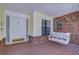 Cozy front porch features brick flooring, swing, and charming details at 124 Barrington Dr, Brandon, FL 33511