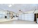 Image of an expansive garage with a clean floor, and an easily accessible automatic garage door system at 124 Barrington Dr, Brandon, FL 33511