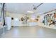 Spacious garage with finished floor, utility sink, storage, and a convenient access door to the backyard at 124 Barrington Dr, Brandon, FL 33511